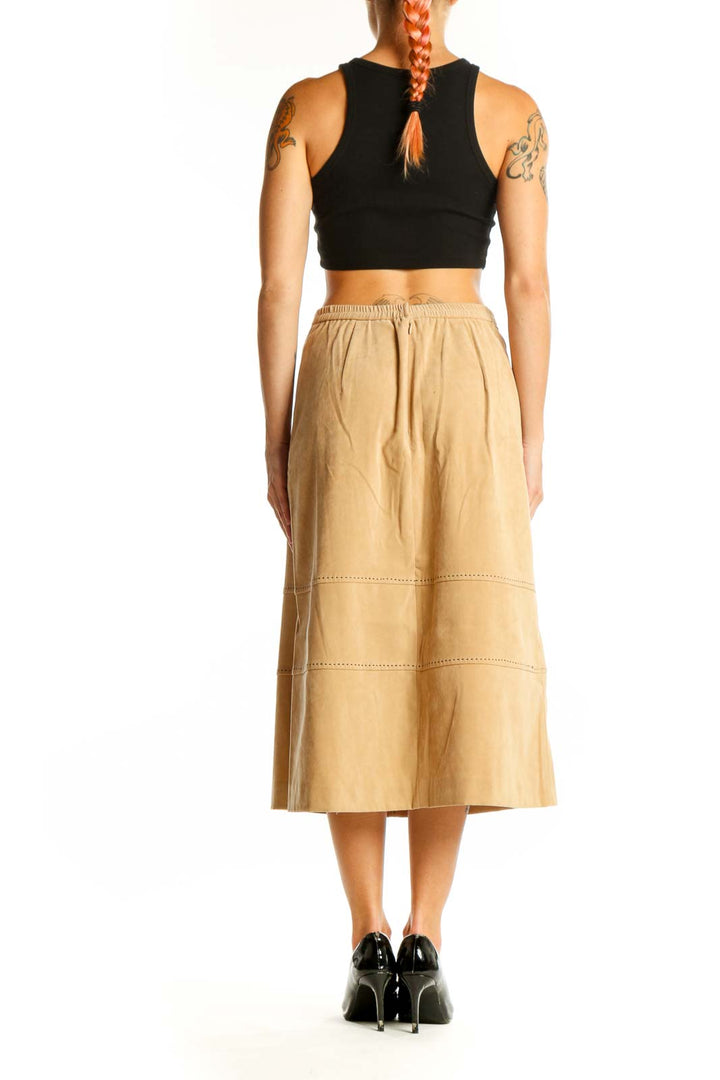 Side view of model wearing Lennie tan suede-look midi skirt with black top