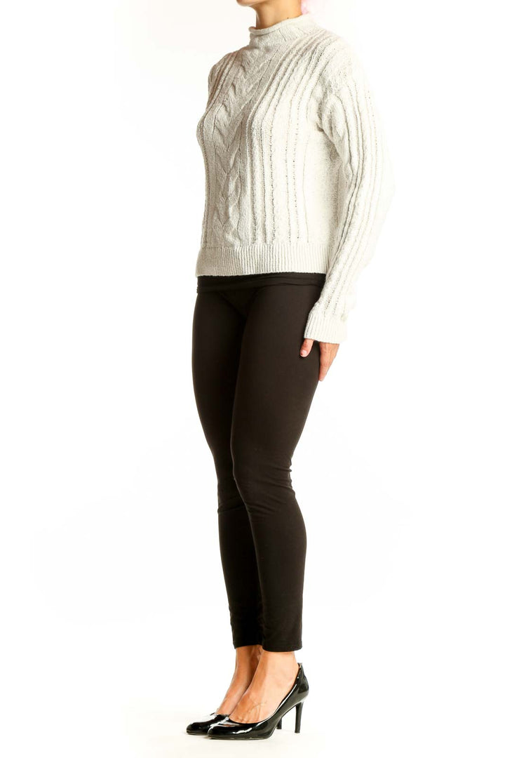 Front view of cream J.Crew cable knit mock neck sweater
