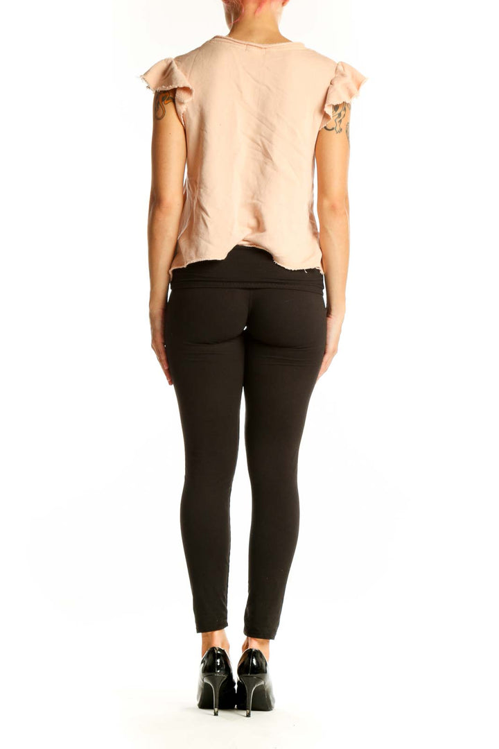 Side view of blush Joie cotton top showing cropped length and fit