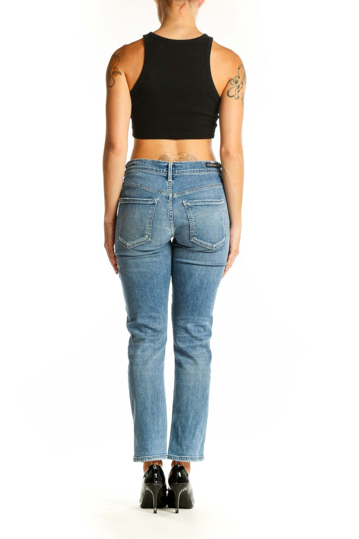 Side view of woman wearing Citizens of Humanity blue embroidered straight leg jeans