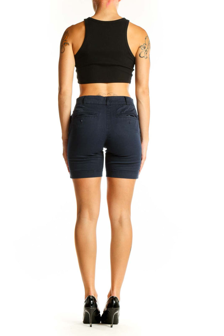 Side view of model wearing J.Crew navy cotton chino shorts with black top