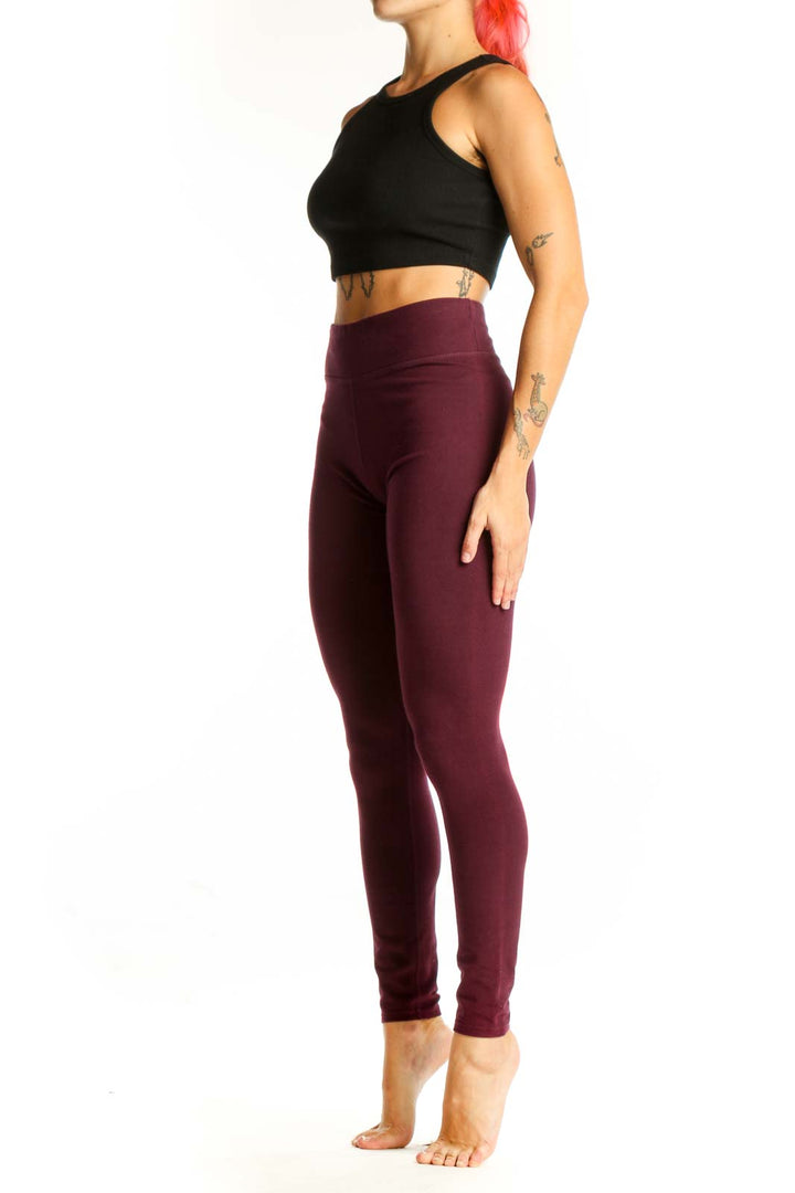 Front view of burgundy high-waisted Pact leggings on model