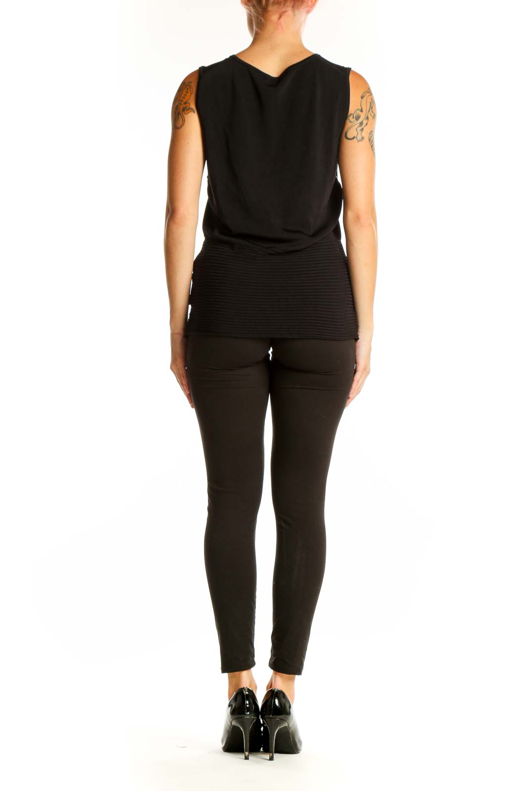 Side view of model wearing black BCBG MaxAzria tank top with dark pants