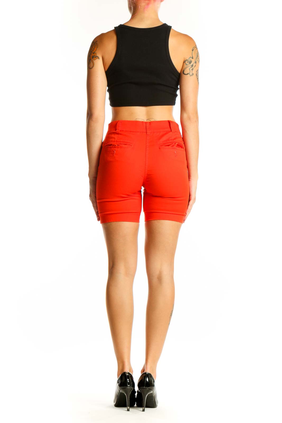 Side view of red J.Crew cotton chino shorts on model with black top