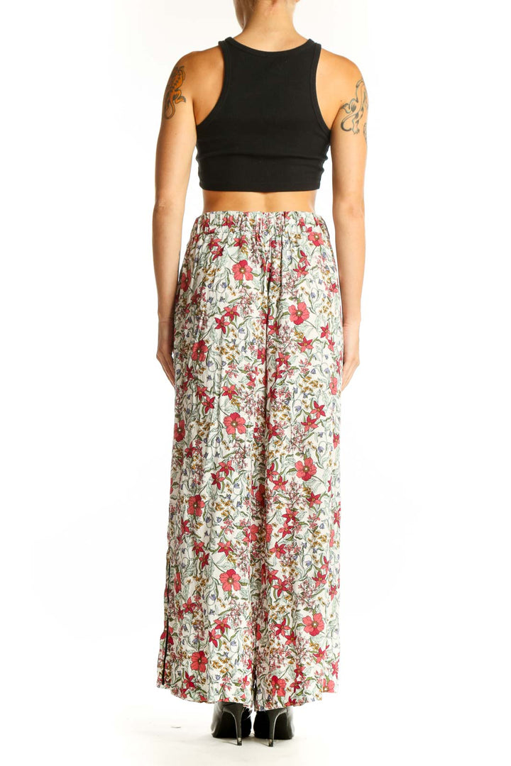 Side view of model wearing Jessica Simpson floral palazzo pants with black crop top