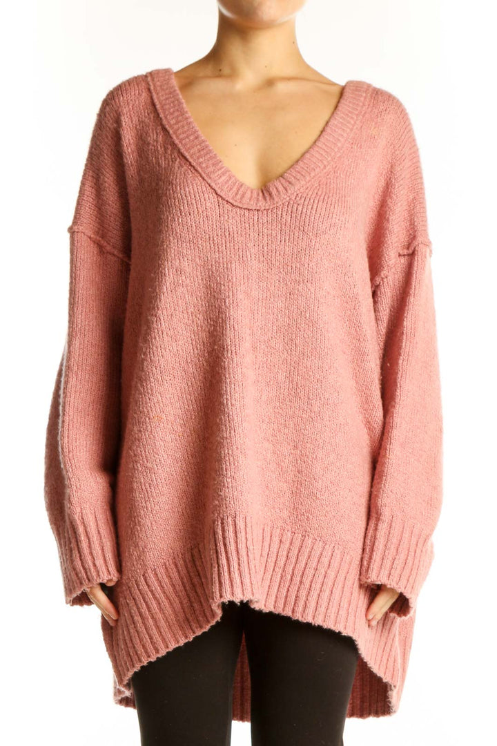 Front view of pink oversized V-neck knit sweater from Free People