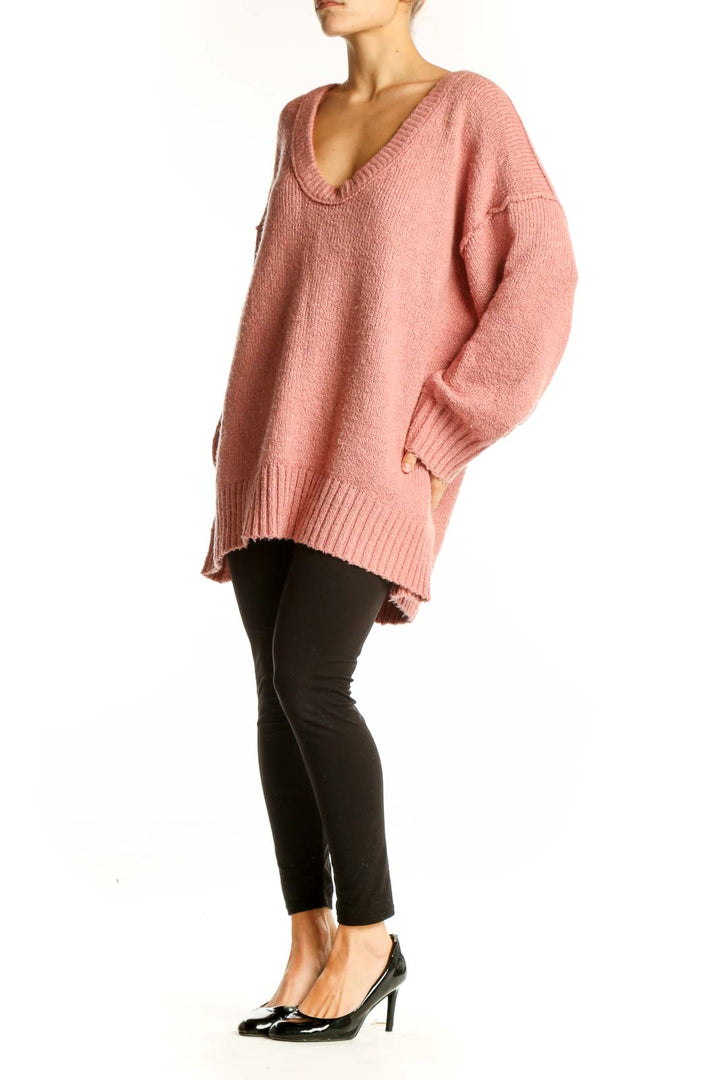 Front view of pink oversized V-neck knit sweater from Free People