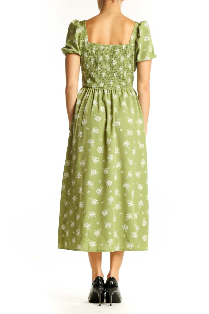 Side view of green floral midi dress showing empire waist and side slit