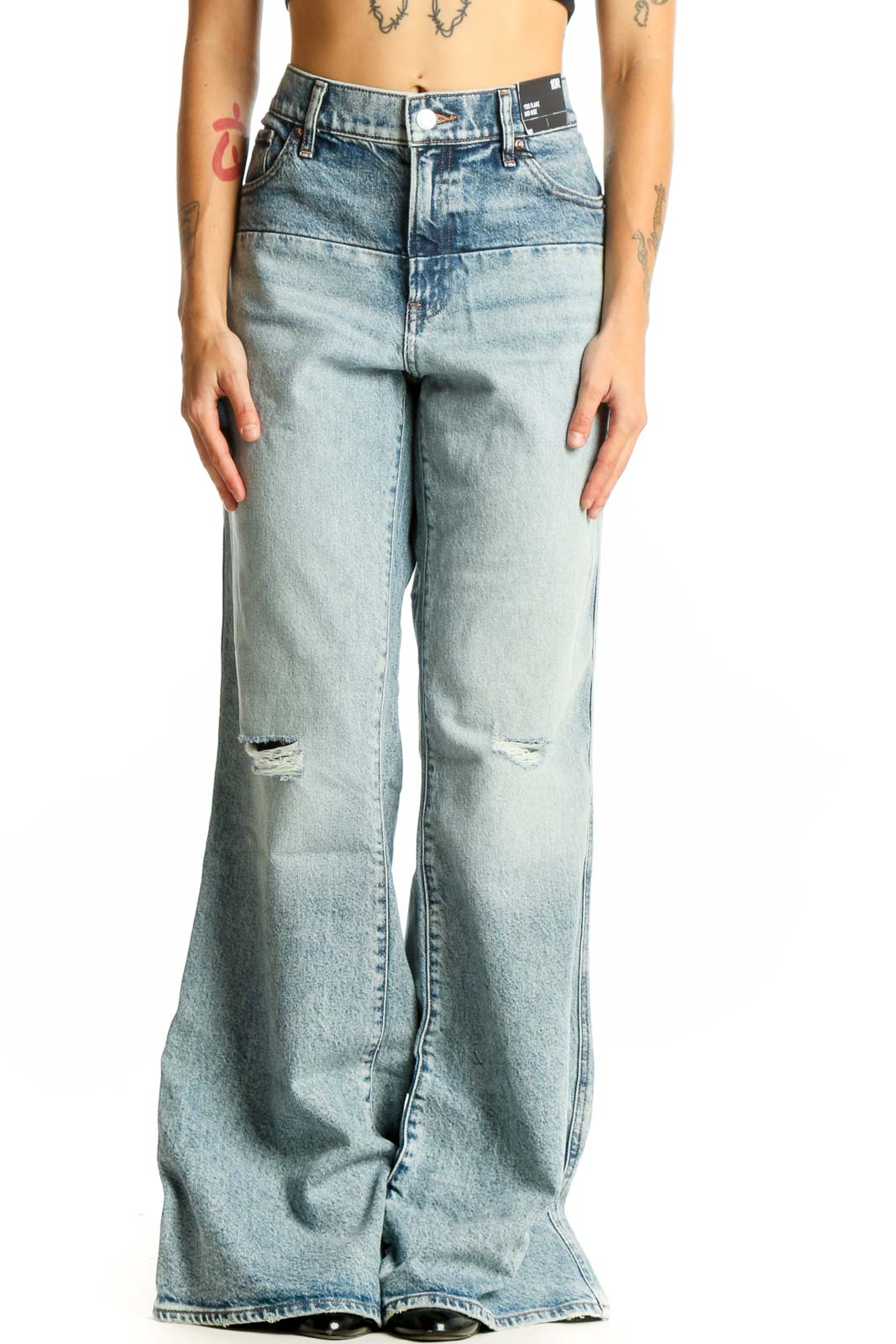 Front view of Gap light blue distressed wide-leg jeans on model