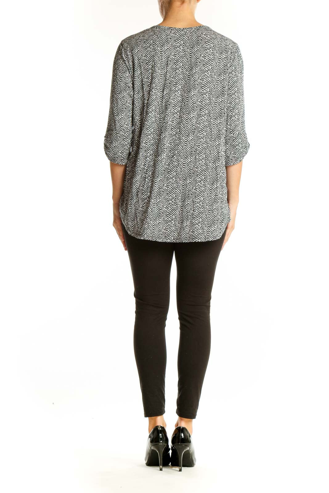 Side view of 41 Hawthorn black and white herringbone print blouse on model