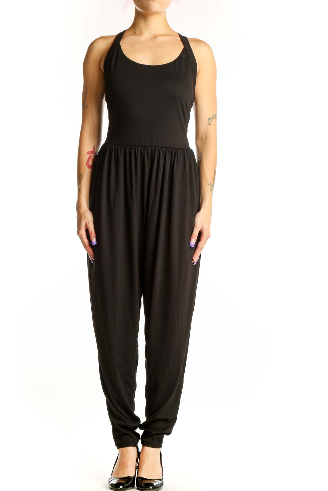 Black Halara jumpsuit with halter neckline and tapered legs, front view on model