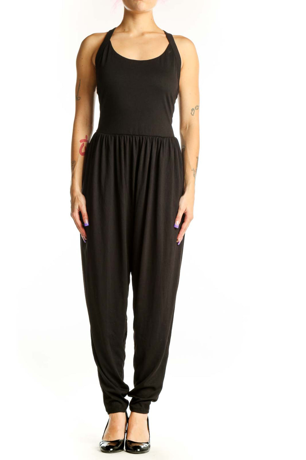 Black Halara jumpsuit with halter neckline and tapered legs, front view on model