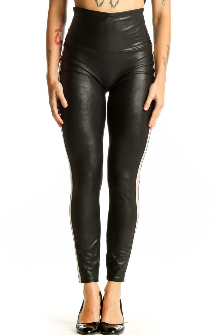 Front view of Spanx black high-waisted faux leather leggings with white side stripe