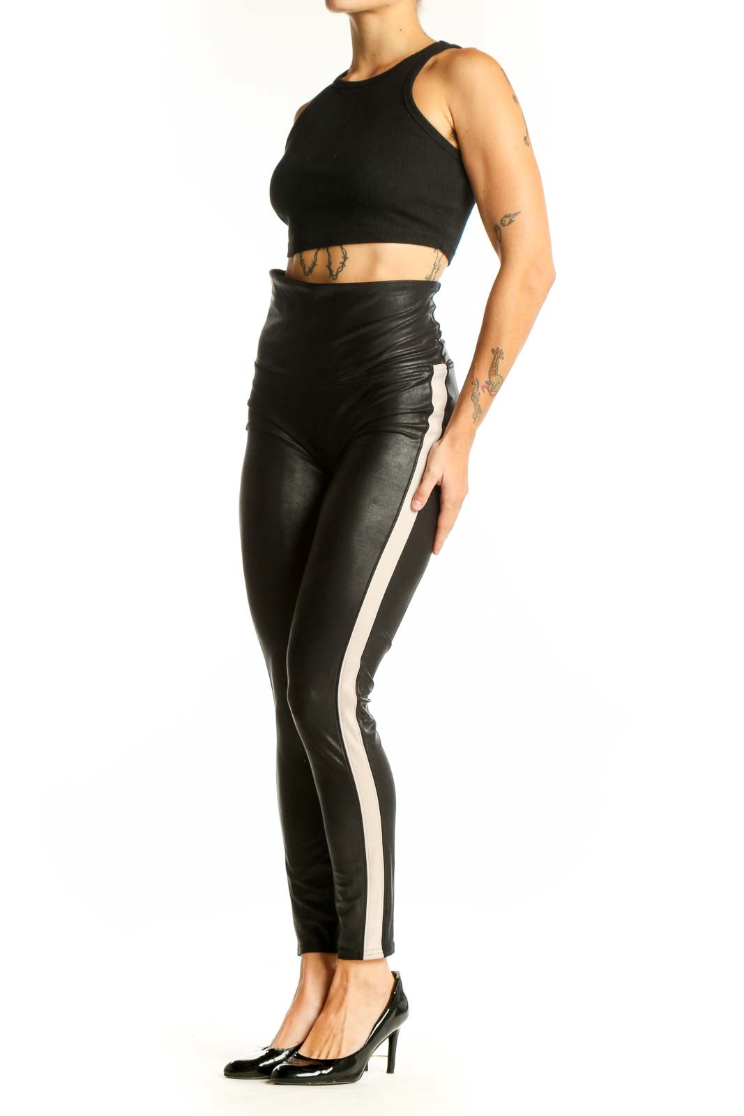 Front view of Spanx black high-waisted faux leather leggings with white side stripe