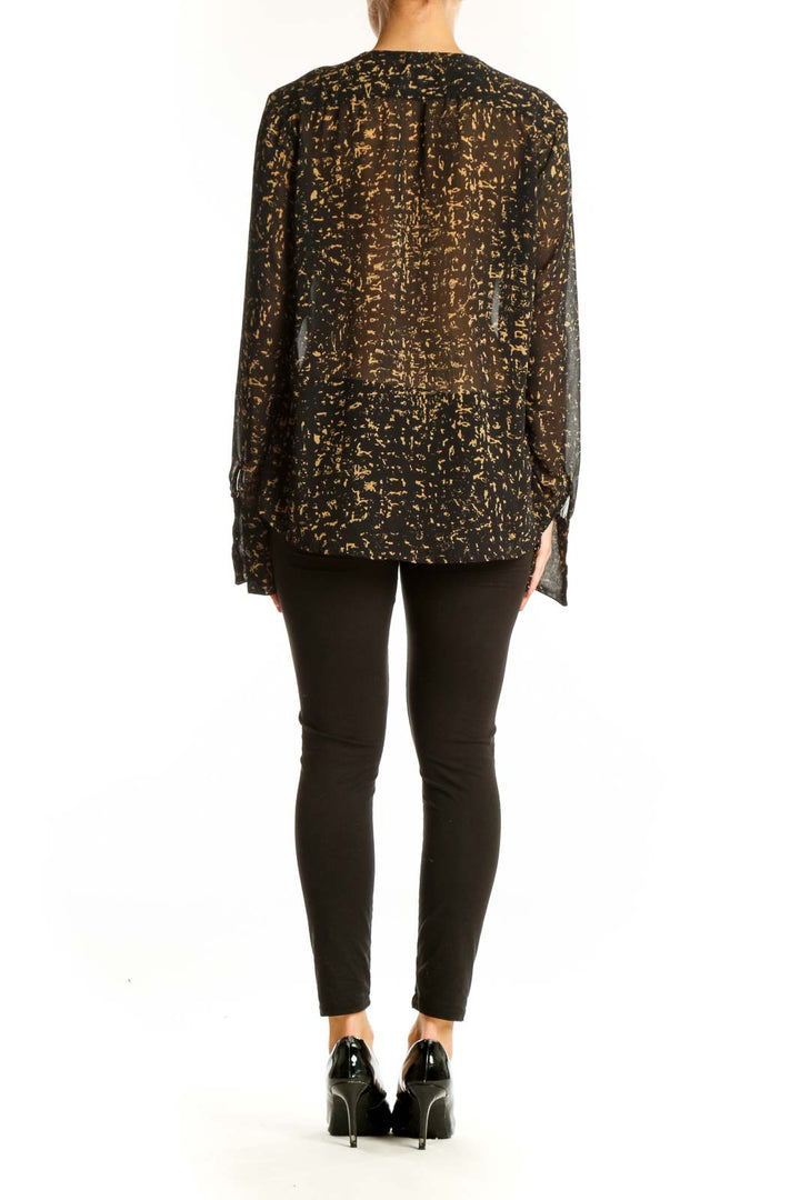 Side view of Converse One Star black and gold abstract print blouse on model