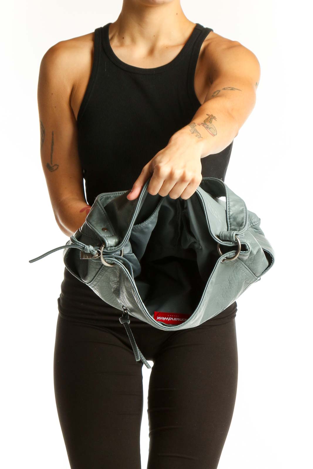 Woman carrying MontanaWest sage green leather tote bag
