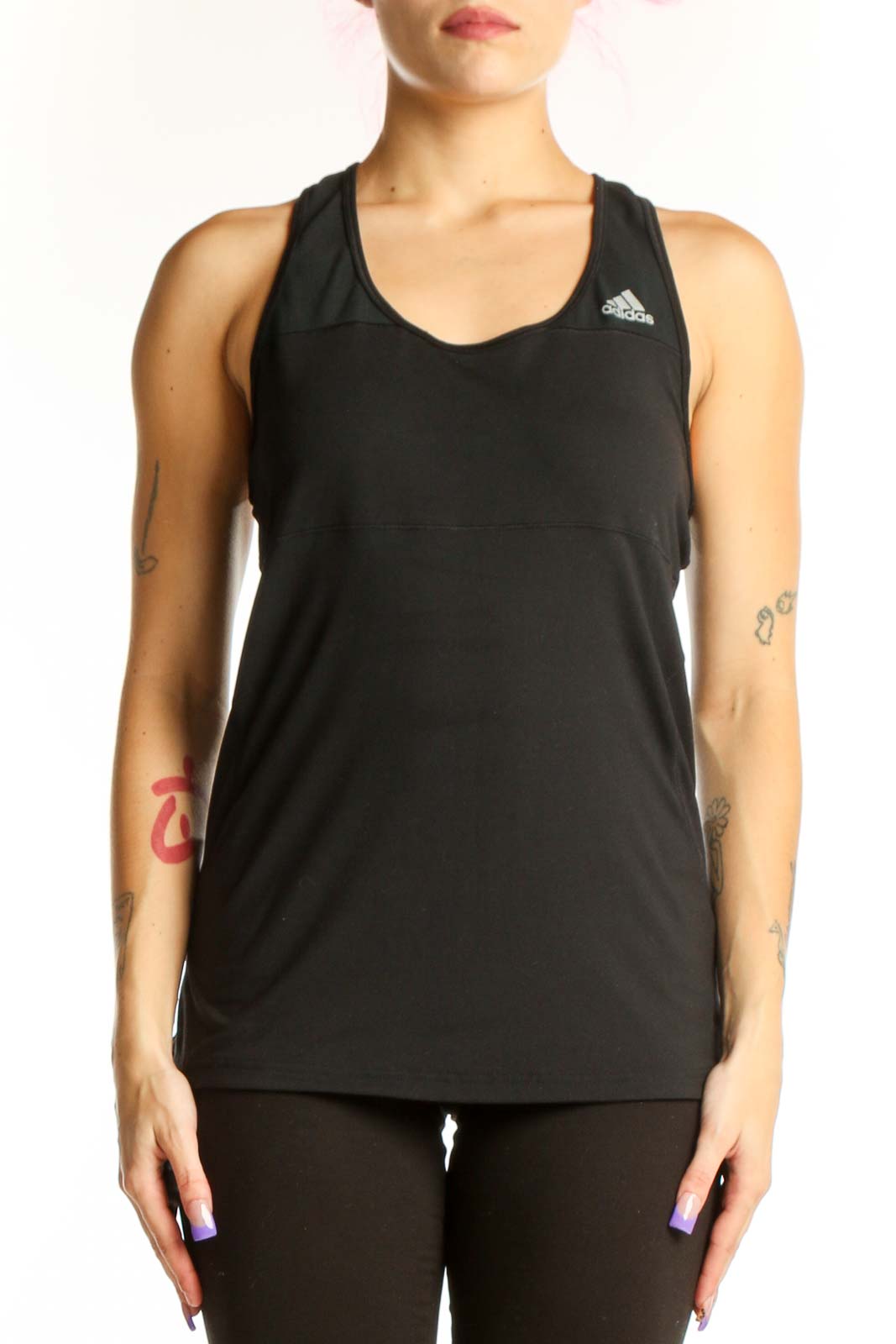 Black Adidas racerback athletic tank top with logo, front view on model