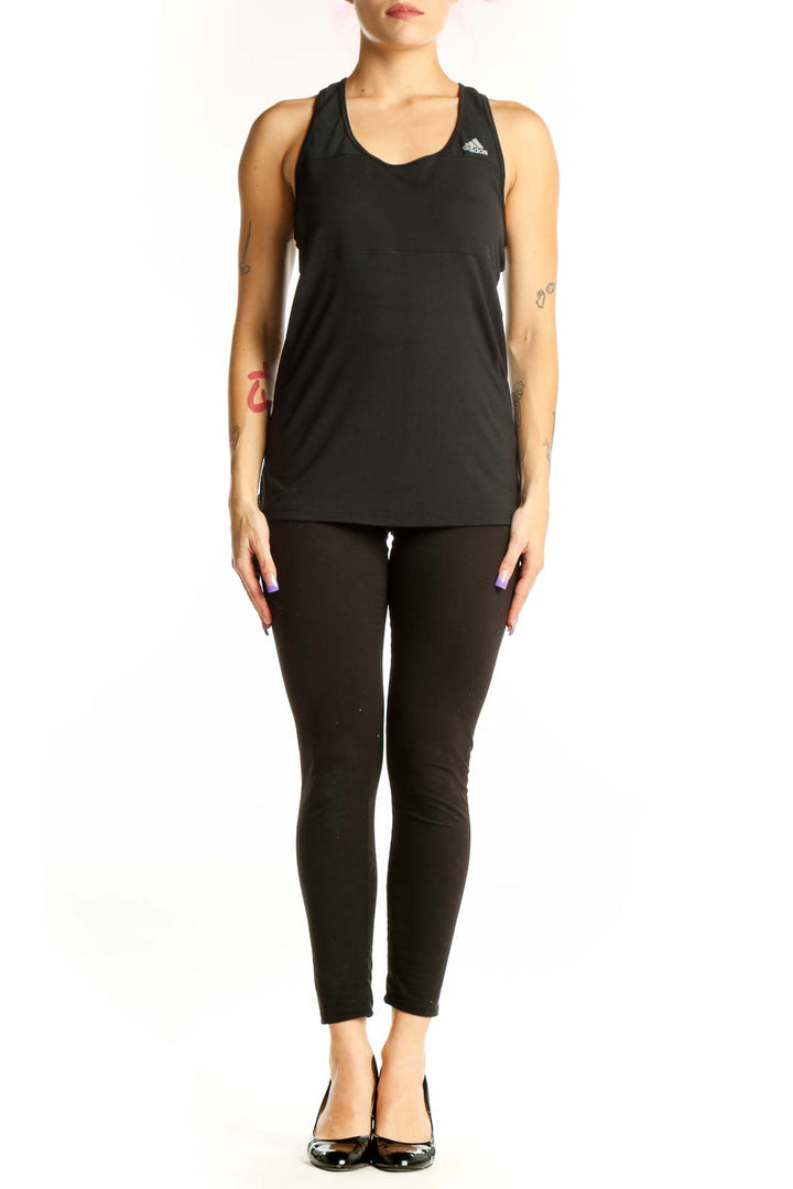 Black Adidas racerback athletic tank top with logo, front view on model