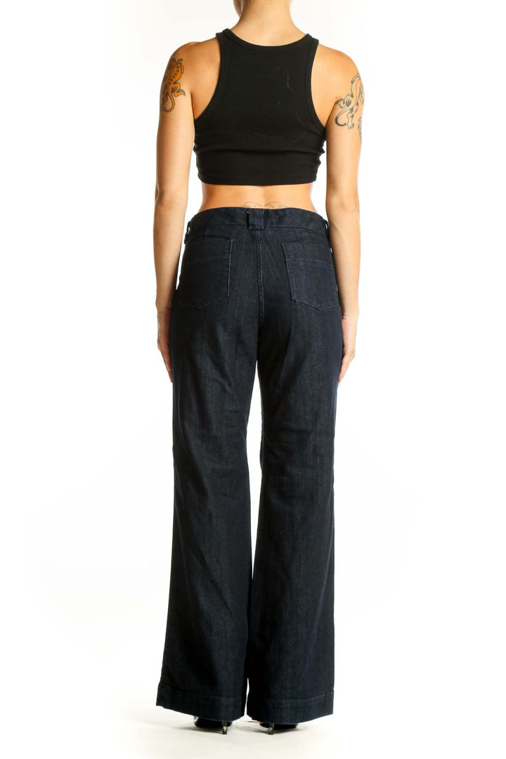 Side view of woman wearing Banana Republic dark blue wide-leg denim trousers