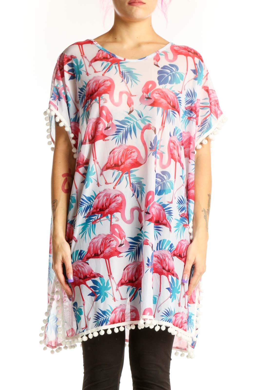 Cream tunic top with coral pink and teal flamingo tropical print, white pom-pom trim on sleeves, front view