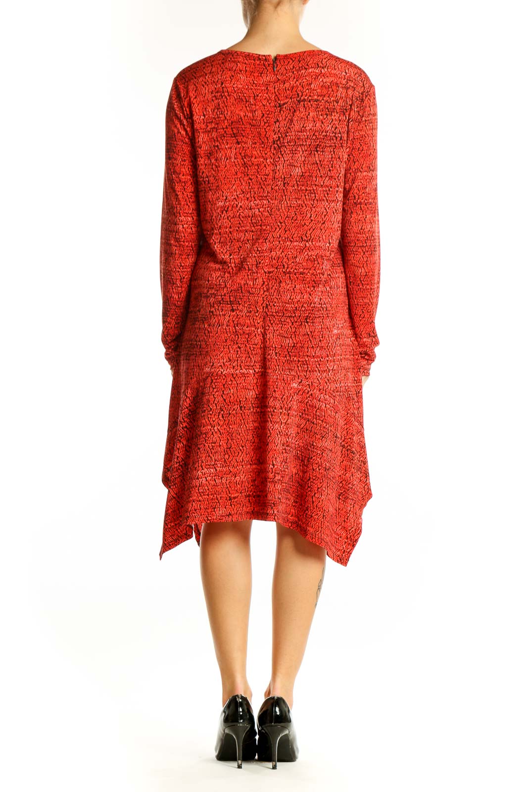 Side view of red textured Michael Kors dress showing asymmetrical hemline