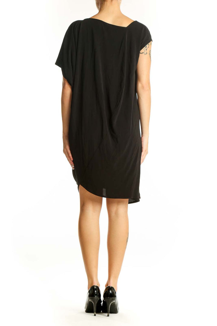 Side view of black asymmetrical draped viscose dress by zero + maria cornejo