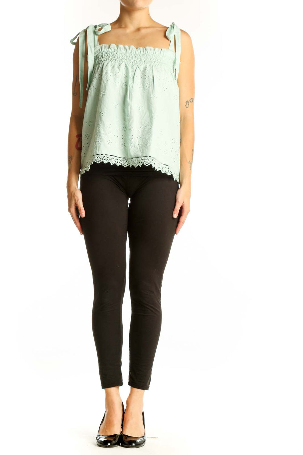 Front view of mint green eyelet lace sleeveless top with tie straps