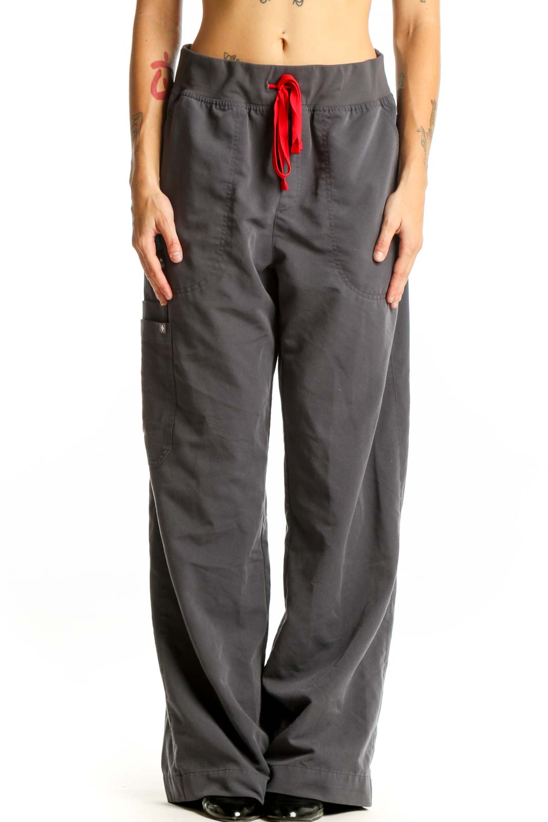 Front view of FIGS gray cargo scrub pants with red drawstring