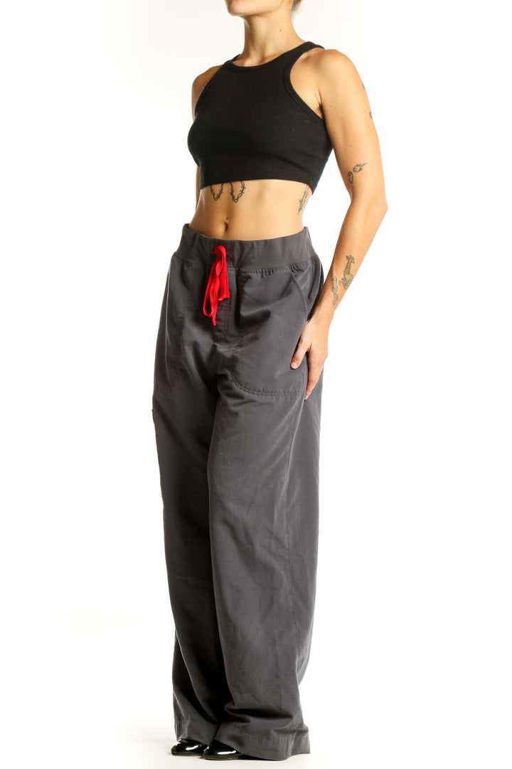Front view of FIGS gray cargo scrub pants with red drawstring
