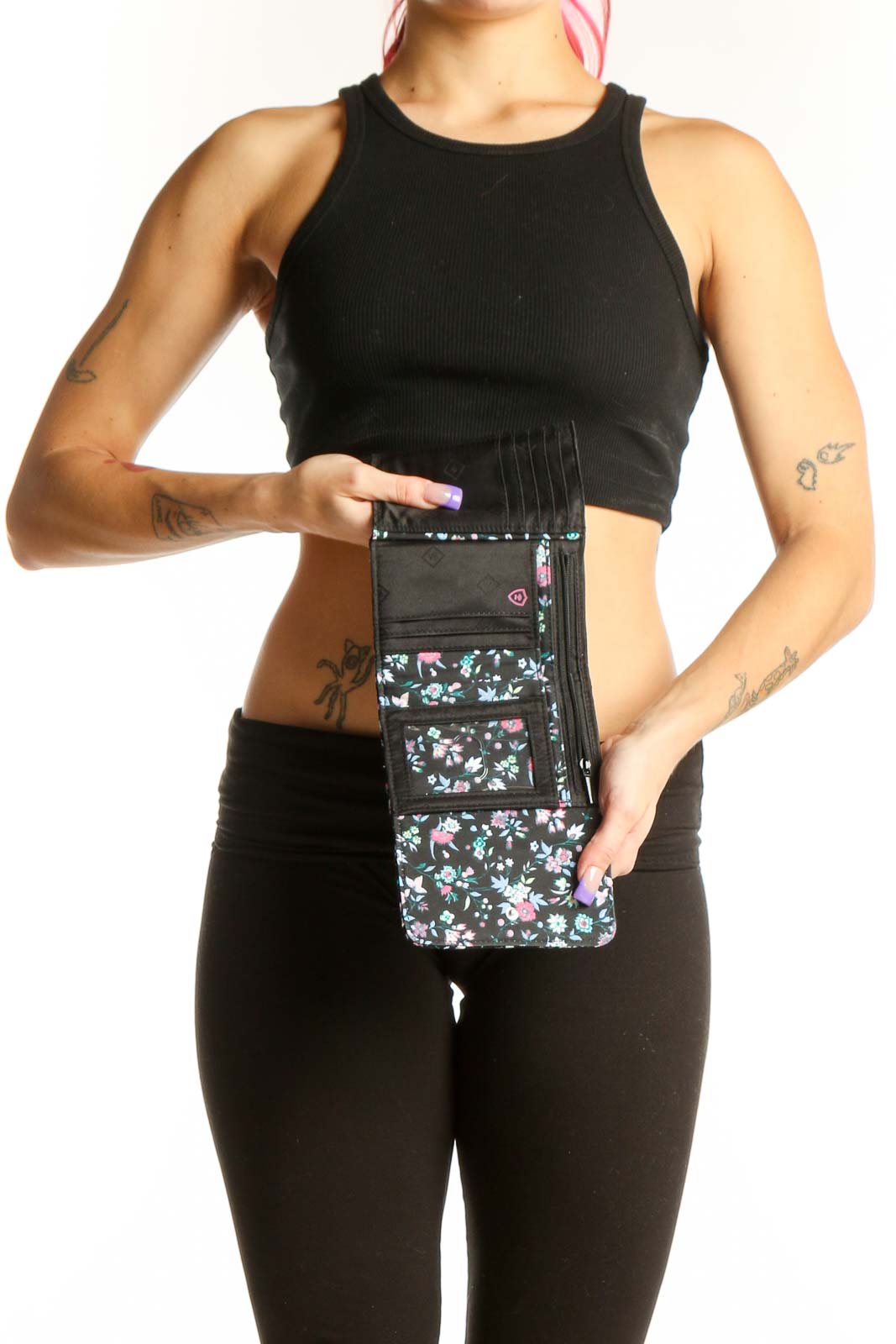 Black Floral Vera Bradley Clutch worn at waist, displaying vibrant floral pattern and quilted construction