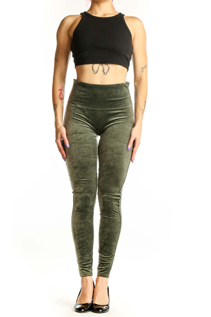 Front view of green velvet Spanx leggings with high-waisted design and full-length cut on model