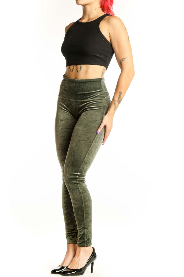 Front view of green velvet Spanx leggings with high-waisted design and full-length cut on model