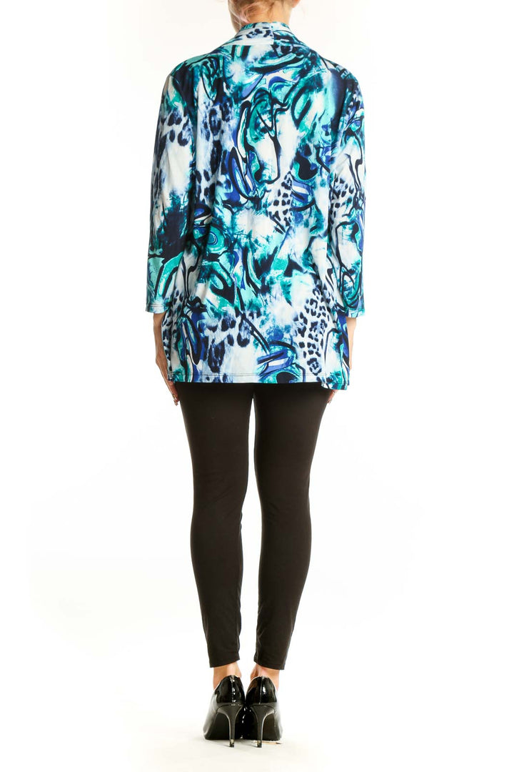 Side view of model wearing Peter Nygard Blue and Teal Abstract Print Cardigan