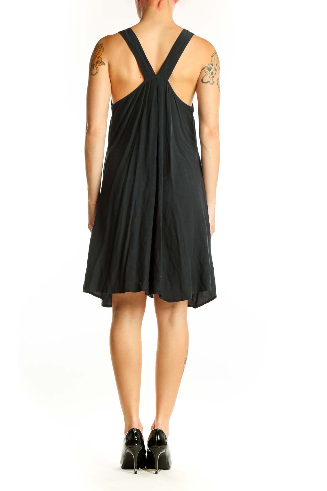 Black V-neck sleeveless dress with asymmetrical hemline, back view showing fluid drape