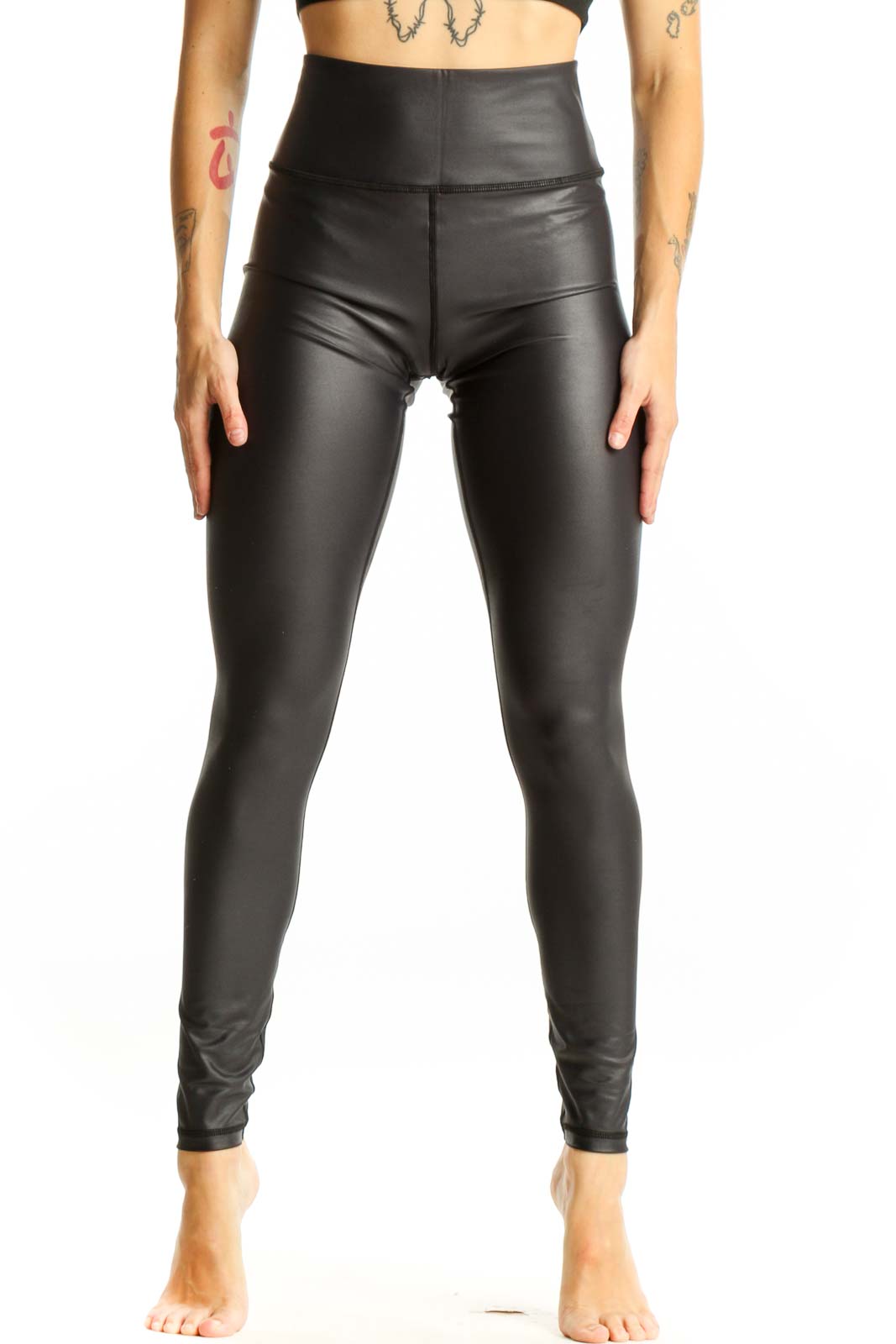 Front view of ZYIA black high-waisted faux leather leggings on model