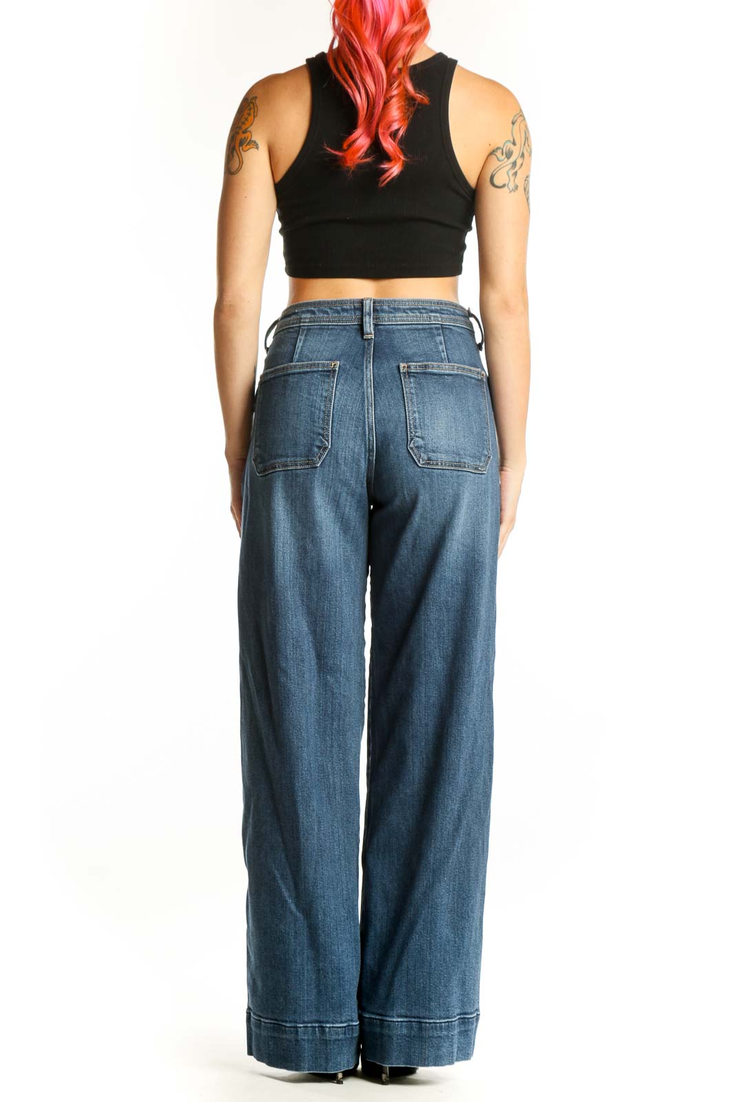 Back view of blue wide-leg cargo jeans showing rear pockets and relaxed silhouette
