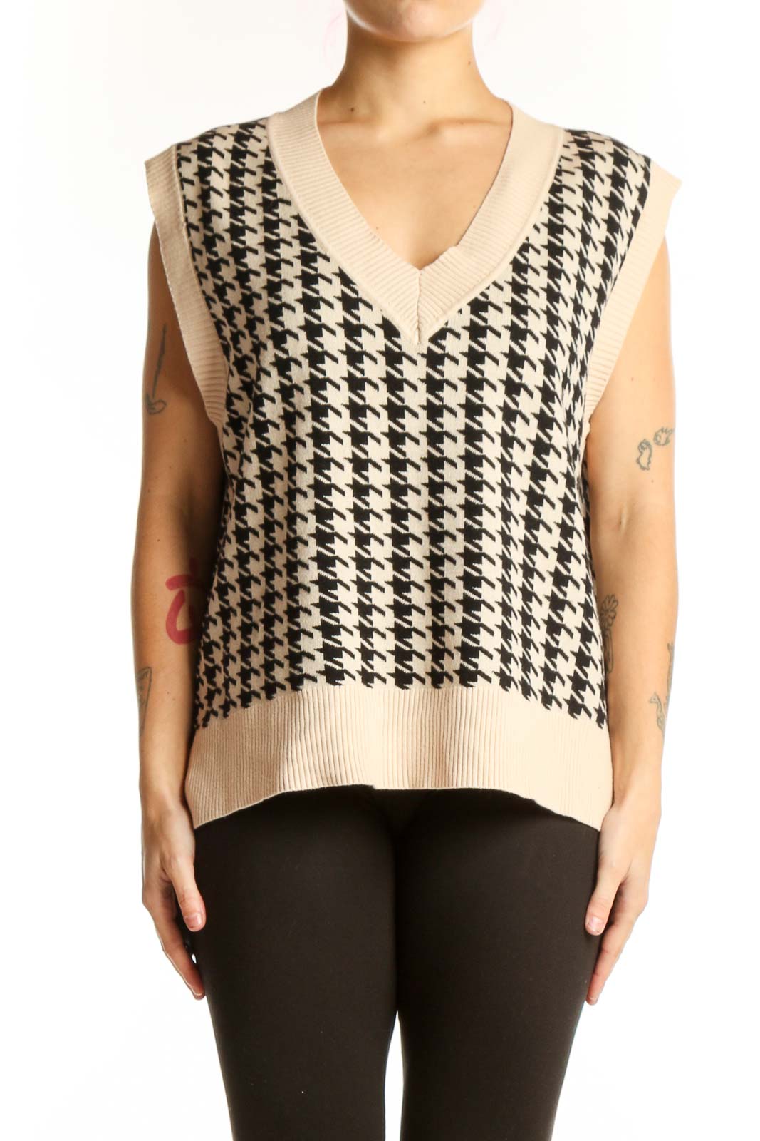 Black and cream houndstooth knit vest with V-neckline and ribbed trim, front view