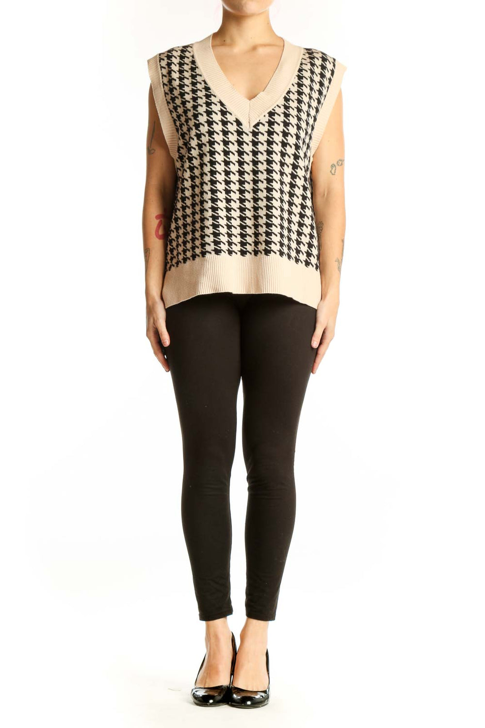 Black and cream houndstooth knit vest with V-neckline and ribbed trim, front view