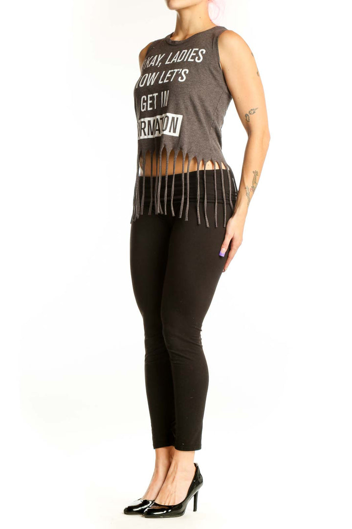 Charcoal graphic cotton tank top with 'Okay Ladies Now Let's Get In Formation' text and black fringe hem detail, front view