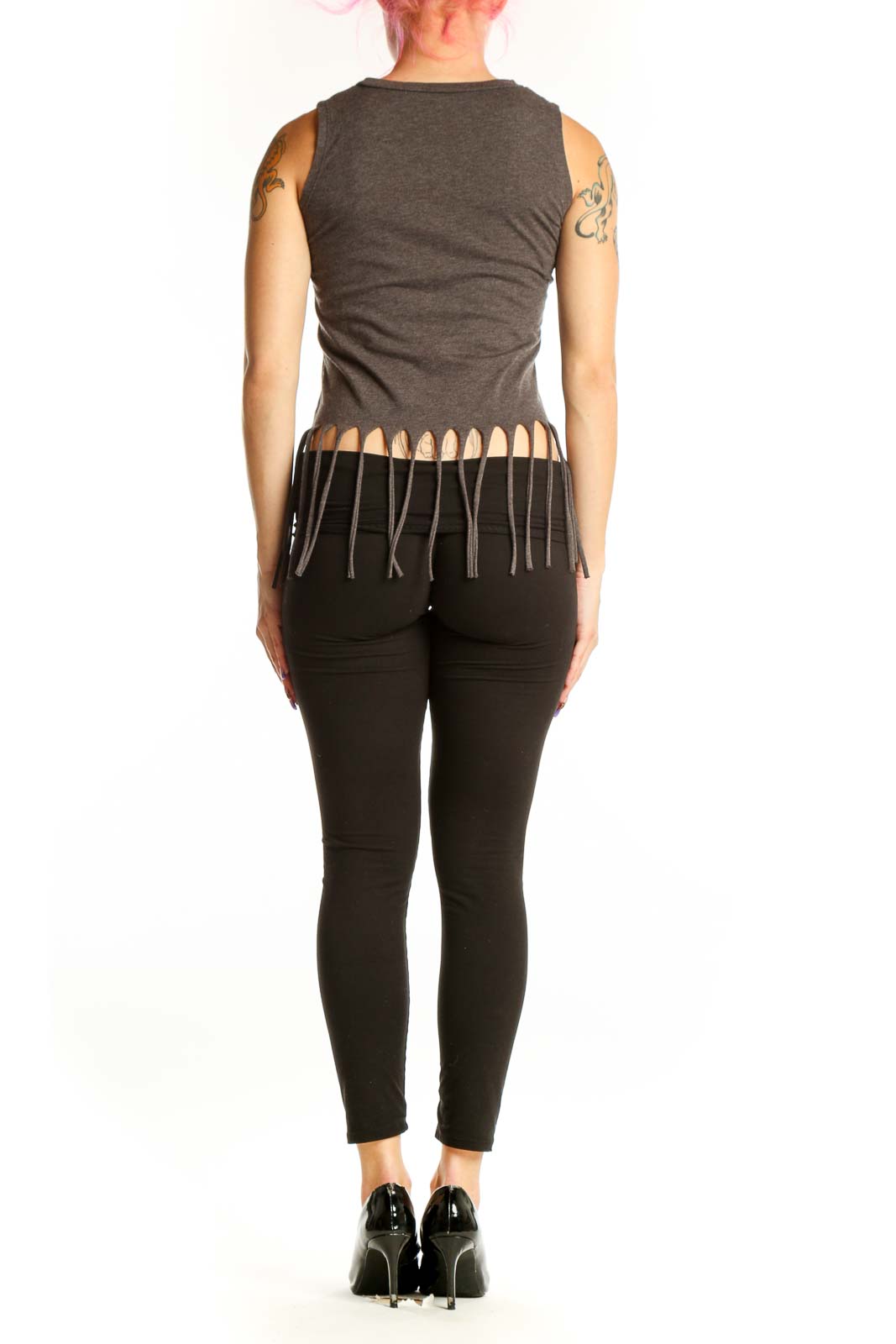 Back view of charcoal cotton tank top with graphic text and fringe detailing, paired with black leggings