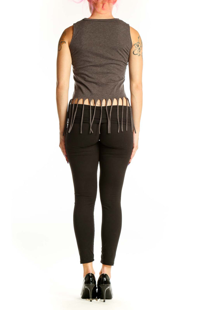 Back view of charcoal cotton tank top with graphic text and fringe detailing, paired with black leggings