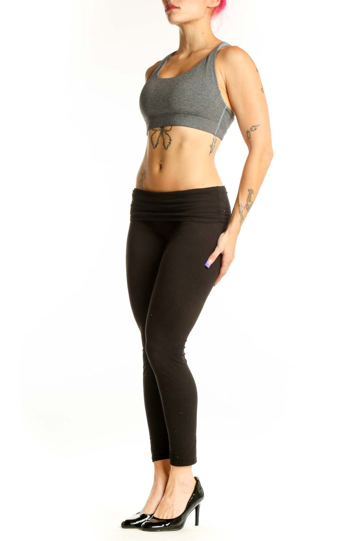 Front view of gray Athleta racerback sports bra with black waistband, size S