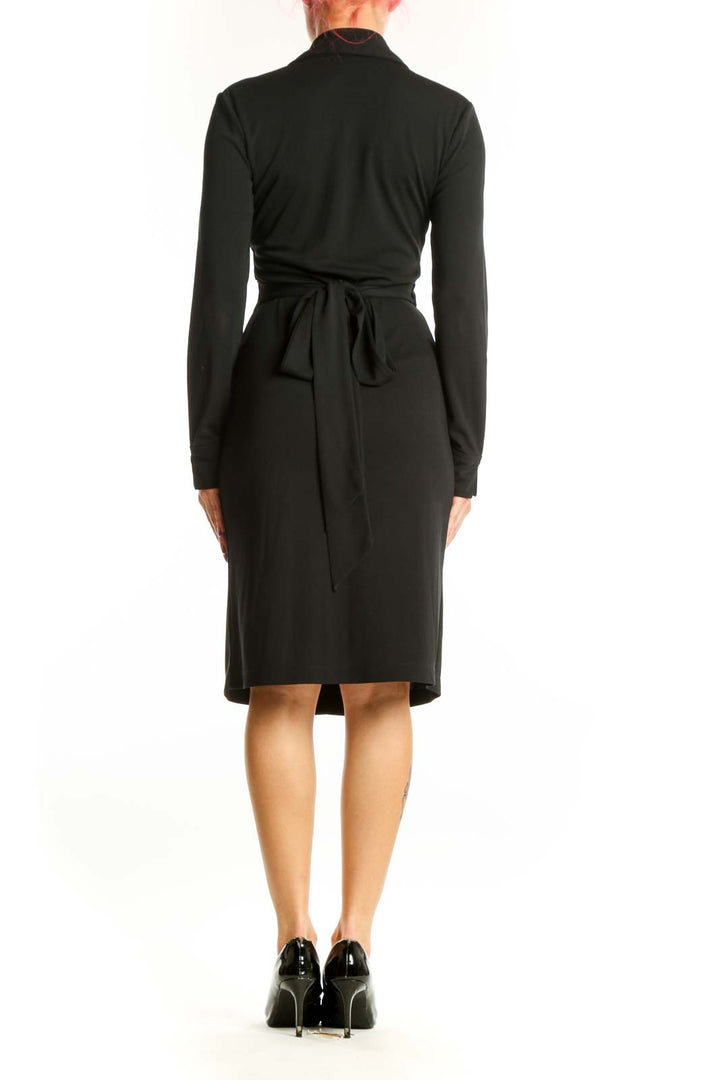 Black wrap long sleeve dress with V-neckline and fitted waist, back view