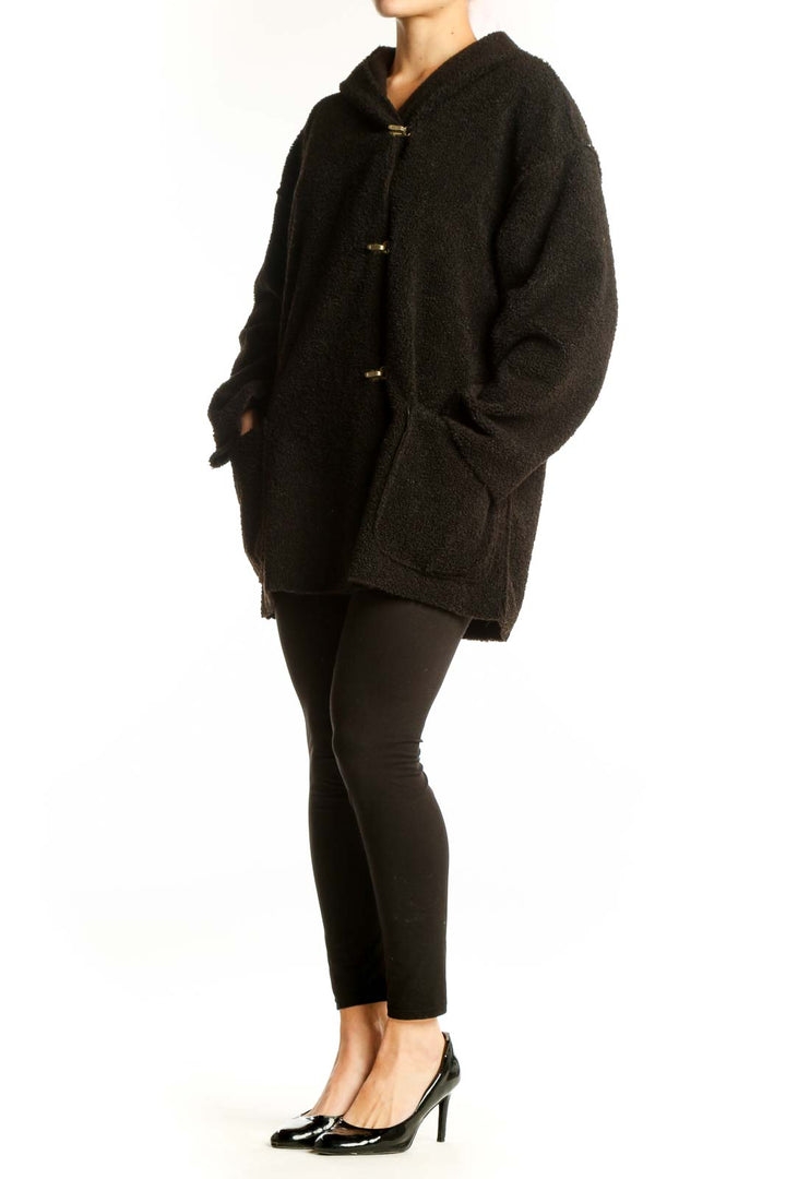 Black hooded polyester jacket with gold buttons and oversized fit, front view