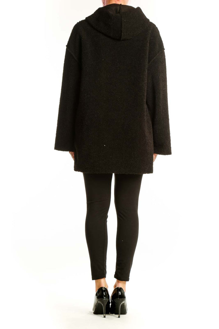 Black hooded polyester jacket with functional pockets and relaxed silhouette, back view