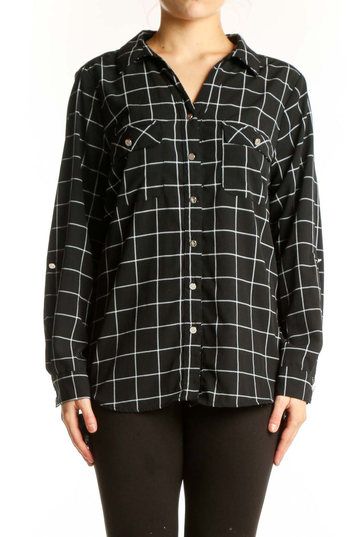 Black and white grid plaid button-up shirt with collared neckline and chest pockets, front view