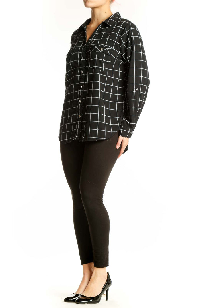 Black and white grid plaid button-up shirt with collared neckline and chest pockets, front view
