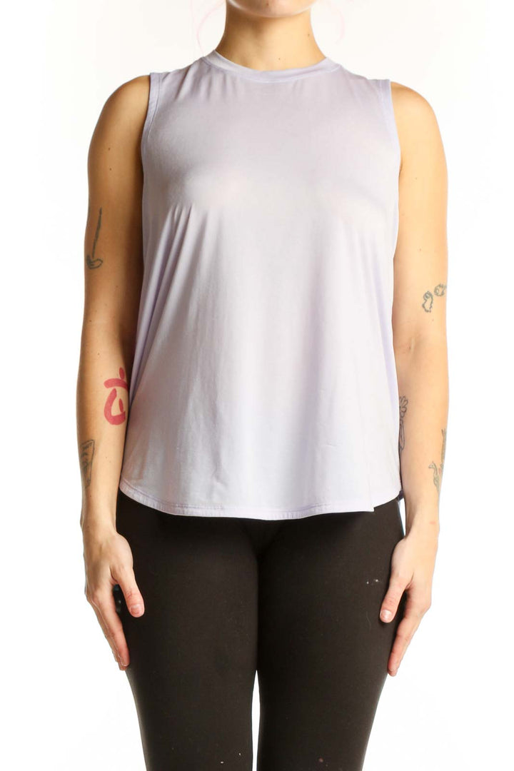 Lavender sleeveless Lululemon tank top worn with black leggings, front view