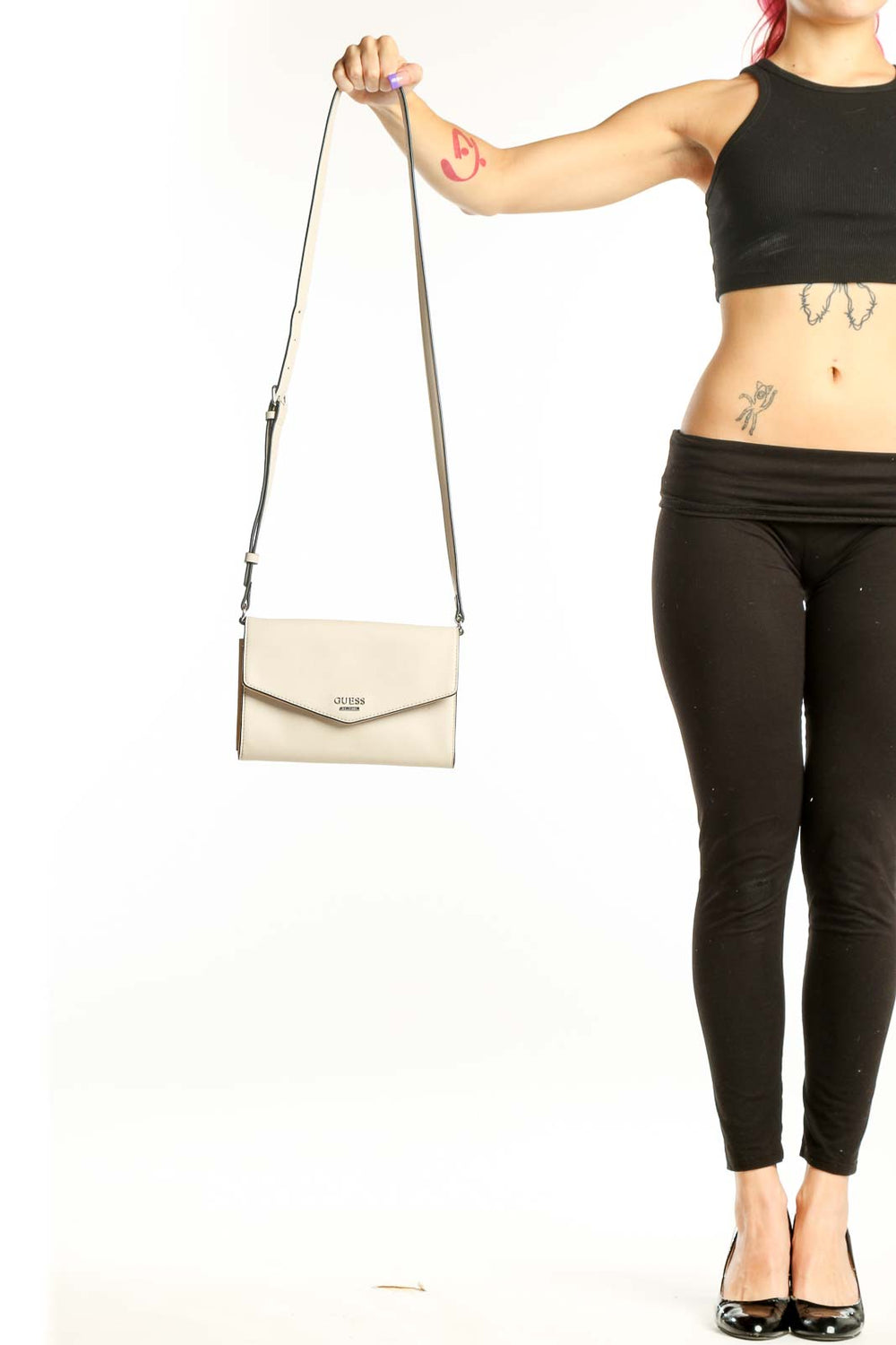 Cream Guess Crossbody Wallet Bag with adjustable strap and envelope flap design held in hand