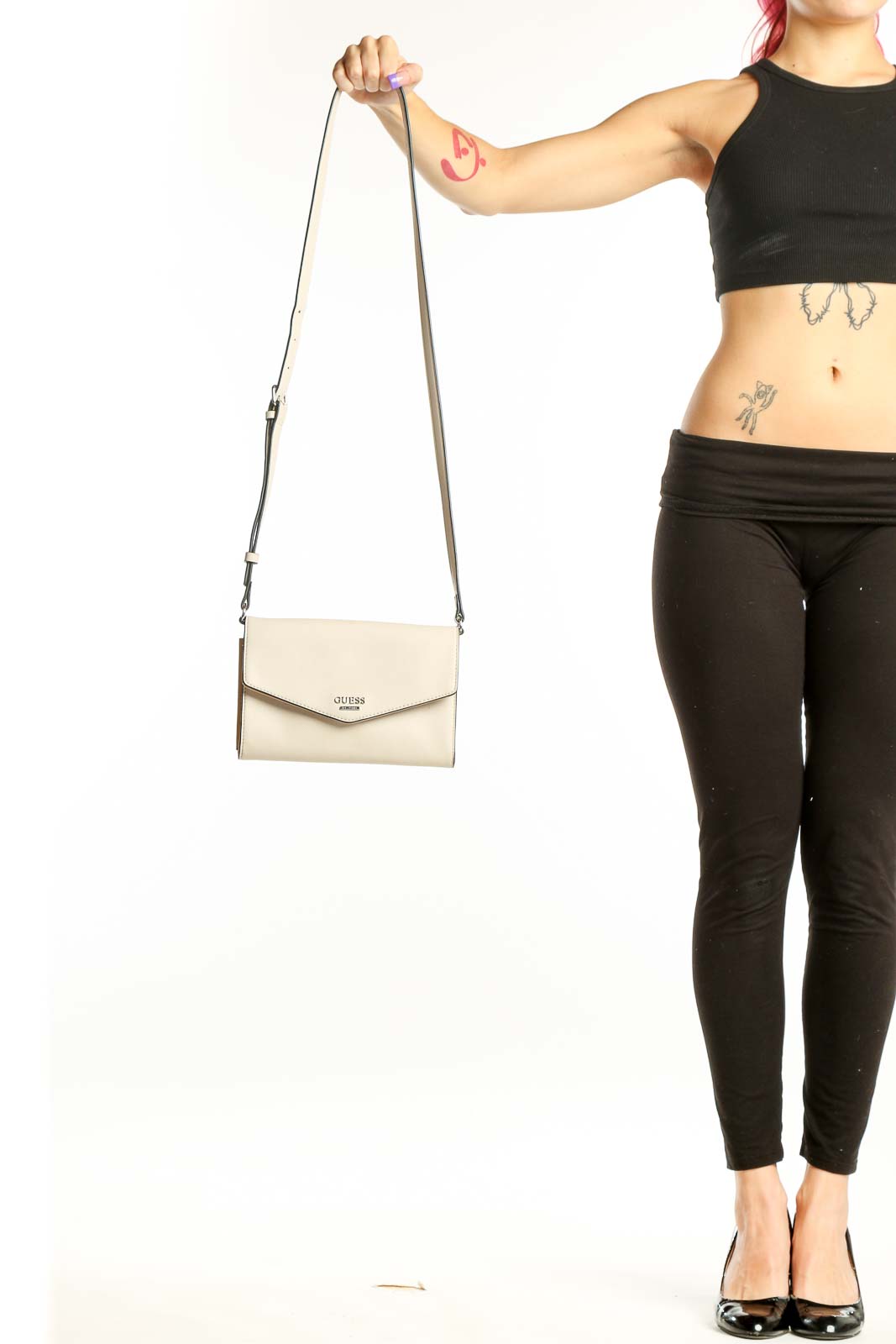 Cream Guess Crossbody Wallet Bag with adjustable strap and envelope flap design held in hand